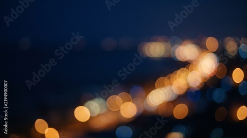 Out of focus street lights create a mesmerizing bokeh effect at dusk, perfect for backgrounds, overlays, or abstract art designs.