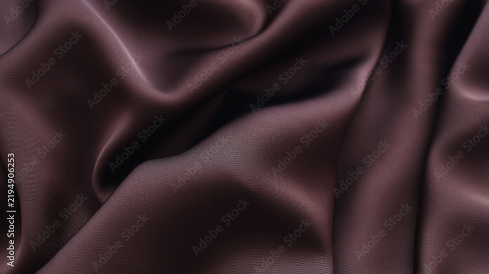 Fototapeta premium Brown silk fabric texture background with elegant satin folds.
