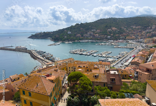 Aerial View of Porto Santo Stefano Harbor with Boats and Coastal Village in Tuscany, Italy