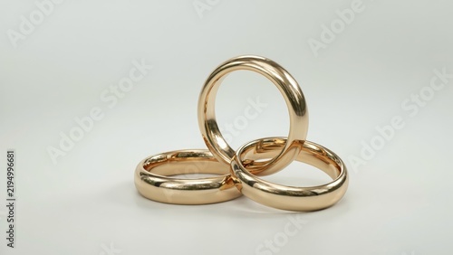 Golden wedding bands gleam against luxurious satin backdrop, perfect for anniversary cards, engagement invitations, or romantic couple celebration designs