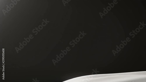 White fabric flowing in the air against a dark background creating a sense of motion and lightness