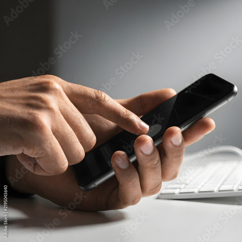 hands of a man using a laptop