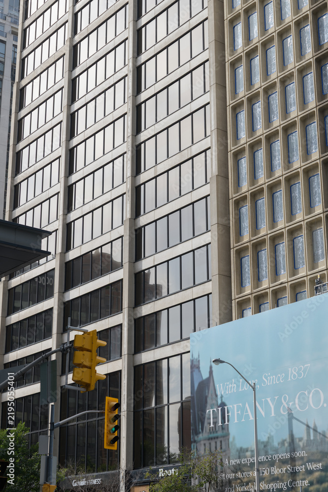 Obraz premium buildings in the Bloor Yorkville area with tarp banner for a future location of Tiffany & Co, 1200 Bay St/66 Bloor St W, Toronto