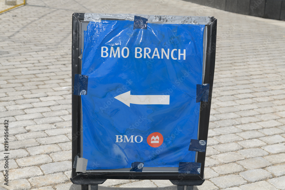 Obraz premium opulently derelict BMO Branch sign with directions to the one at Yonge & Harbour, Toronto
