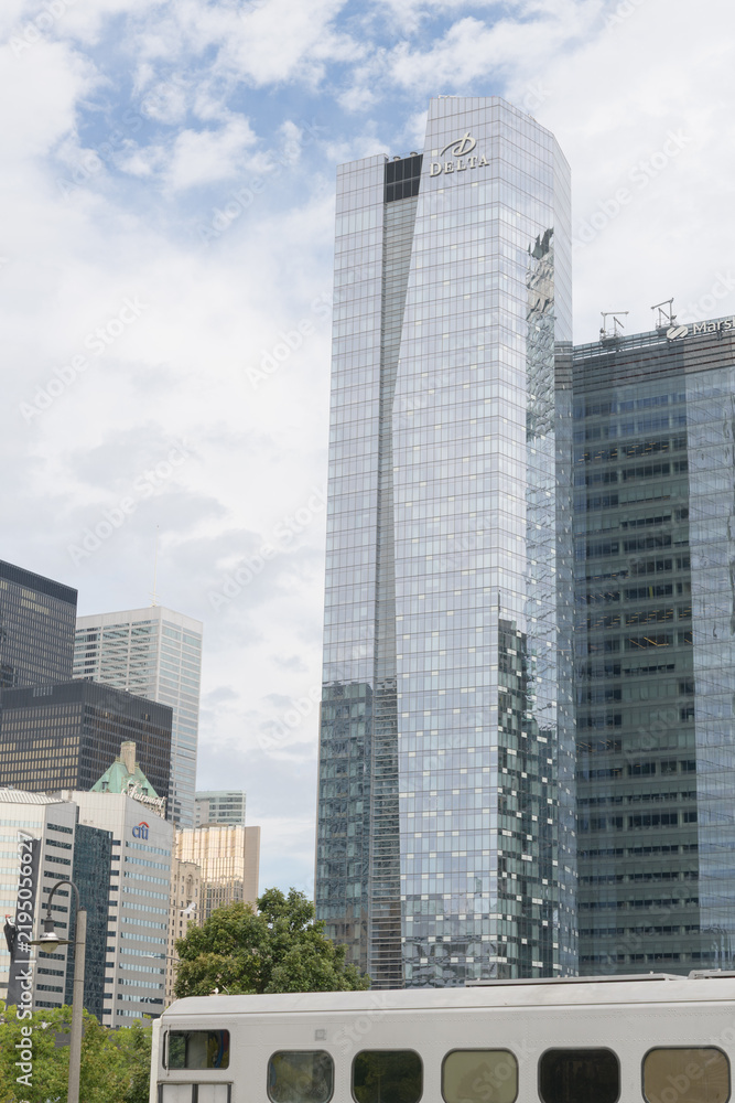 Obraz premium (at left) financial district and cloudy clearing in the sky and view of Delta hotel / Southcore Financial District buildings, Toronto