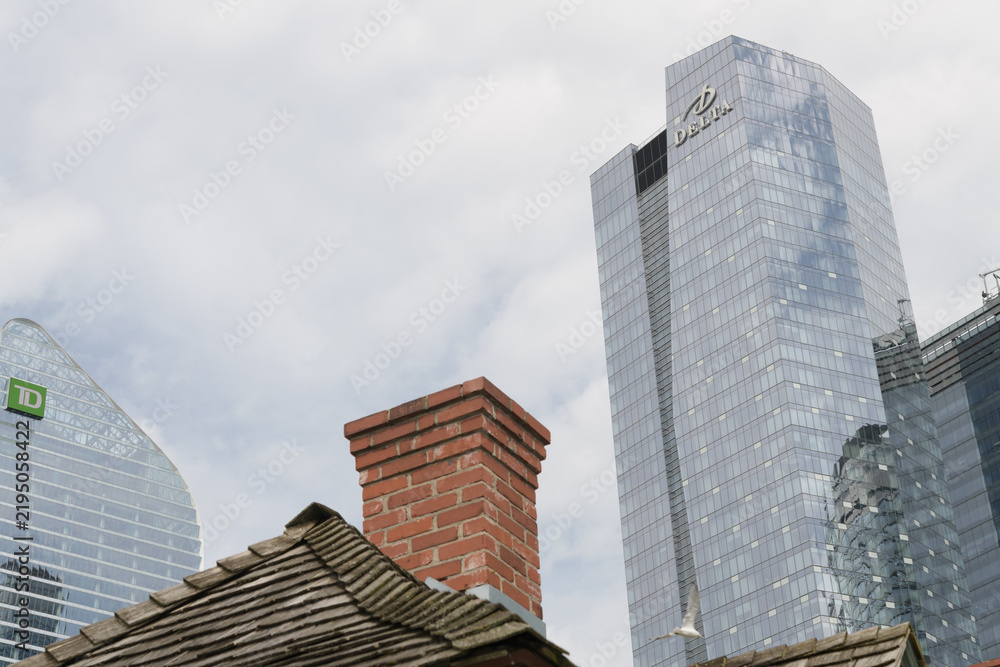 Obraz premium TD Terrace (160 Front St W), historic roof line and chimney of historic station at Railway Museum, and Delta Hotel (75 Lower Simcoe) seen from Roundhouse Park, Toronto