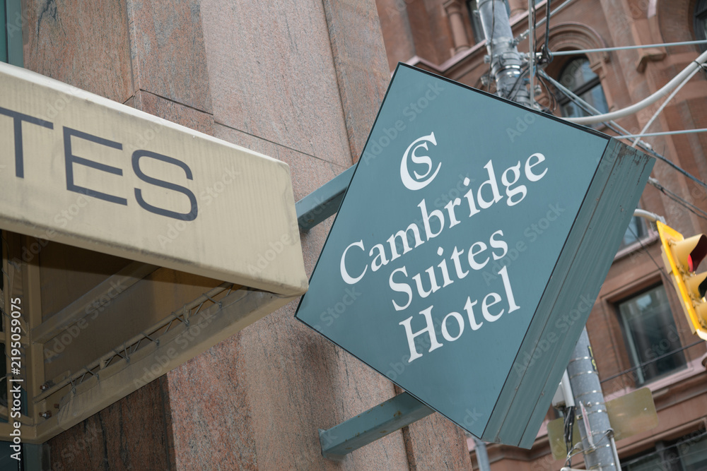 Obraz premium sign outside Cambridge Suites Hotel, a four-star hotel, located at 15 Richmond St E, Toronto