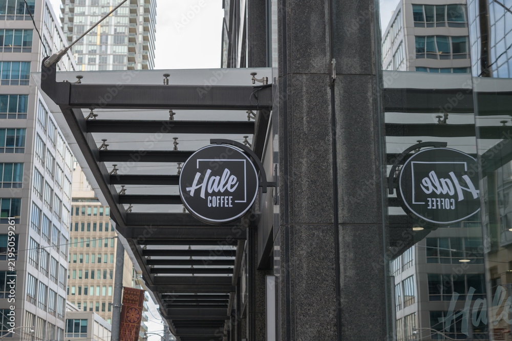 Obraz premium wall-mounted round projecting sign outside Hale Coffee Company located here at 1 Adelaide St E, Toronto