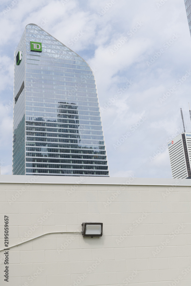 Obraz premium TD Terrace, designed by Adrian Smith + Gordon Gill Architecture (AS+GG), with corporate logo sign and a concrete block wall, Toronto