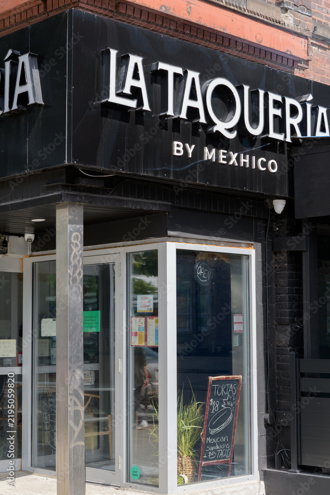 Obraz premium exterior building facade and sign of La Taqueria by Mexhico located at 221 Spadina Av, Toronto