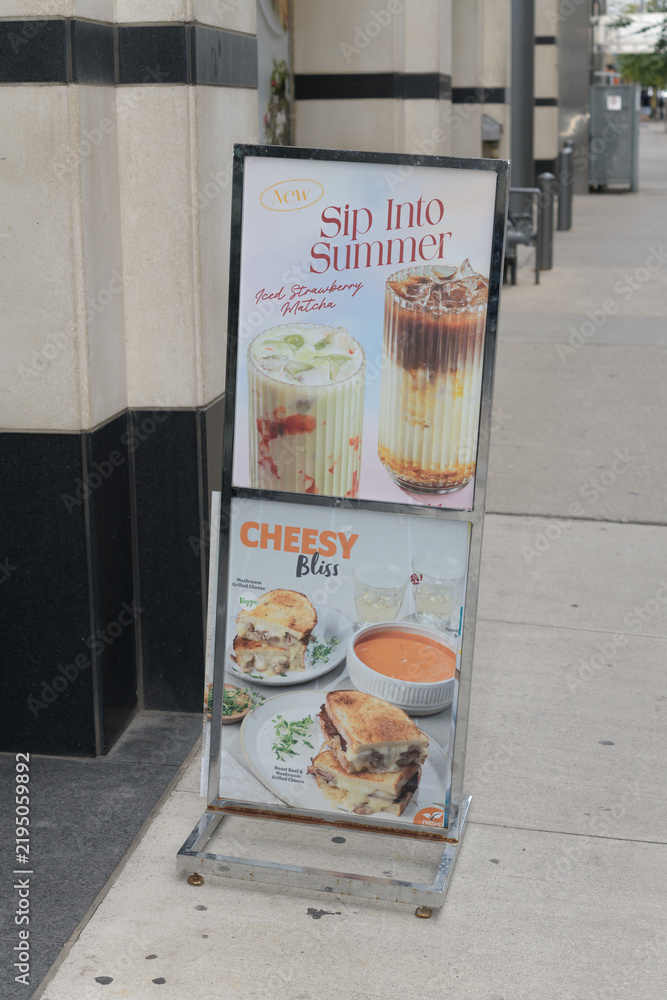 Obraz premium freestanding metal poster frame with menu options ads outside Au Pain Doré, a pastry shop, located here at 20 Adelaide St E, Toronto