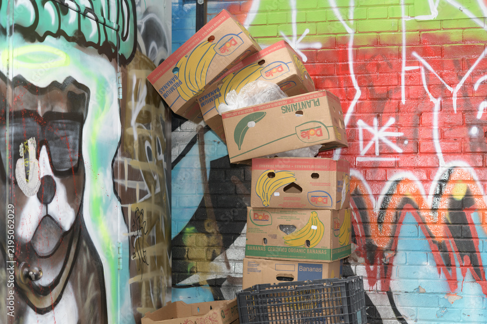 Fototapeta premium discarded cardboard Dole banana boxes in Graffiti Alley, Toronto