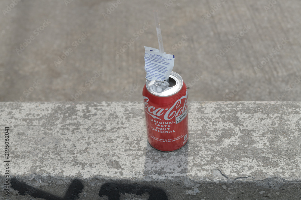 Fototapeta premium discarded wipes wrapper and can of Coca-Cola in Toronto