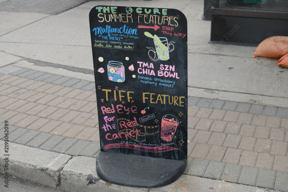Obraz premium sidewalk black marker board of The Cure by TMA, a health food restaurant, located at 19 Mercer St, Toronto