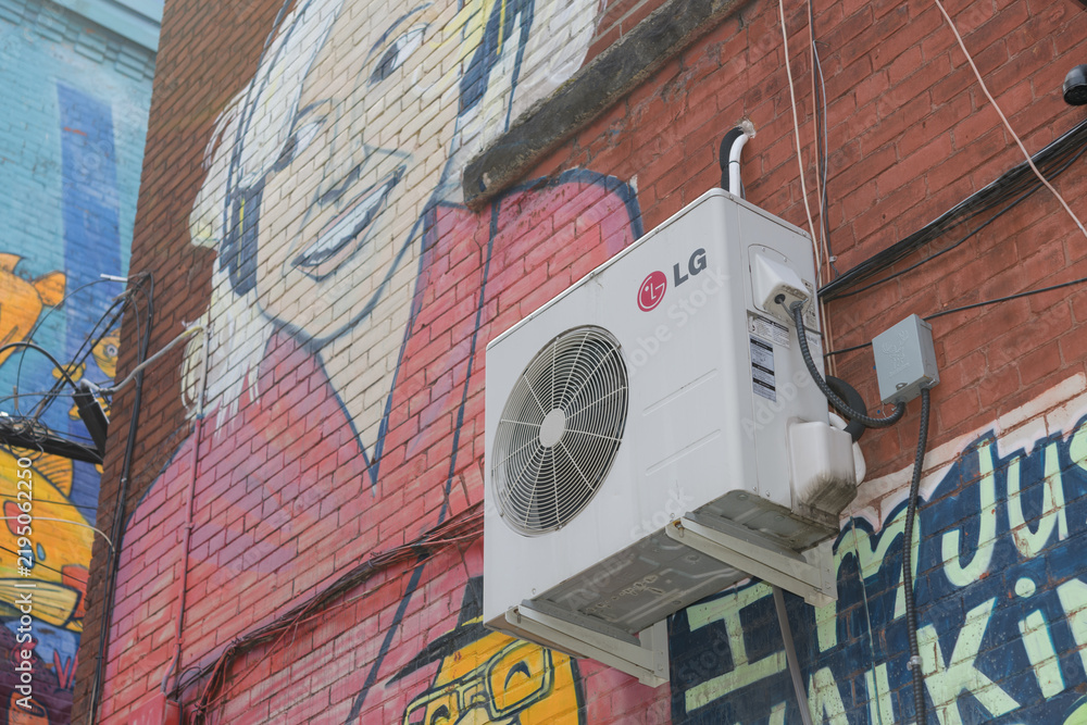 Fototapeta premium LG AC unit mounted to a wall with air-inlet/return grille or discharge grille and mural in Toronto