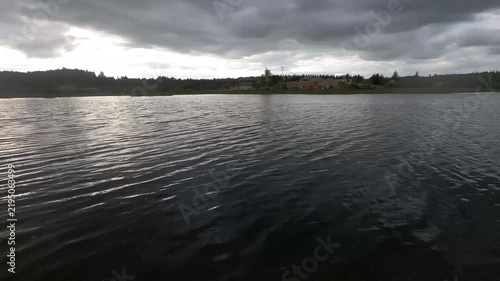 Rippling Lake Water Reflecting Light Beneath Cloudy Sky