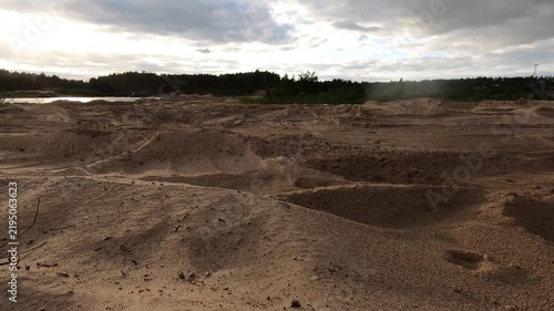 Sandy Mounds and Shallow Hollows Under a Cloudy Sky