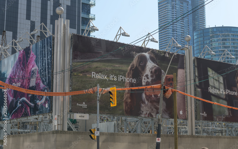 Obraz premium Apple Inc advertising banners at the southwest corner of Wellington St W and John St, Toronto (