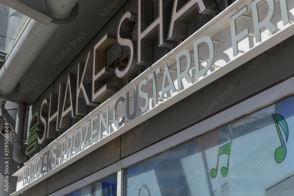 Obraz premium exterior building facade and sign of Shake Shack, a hamburger restaurant, located here at 10 Dundas St E, level 1, inside The Tenor, Toronto