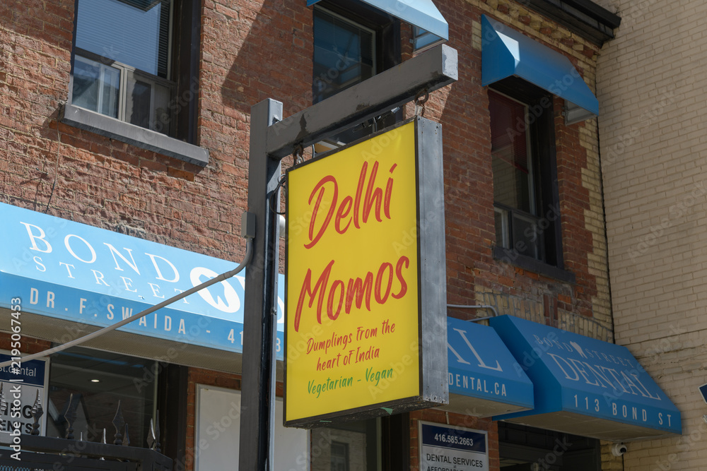 Obraz premium sign outside Delhi Momos and Indian Nepalese style restaurant, located at 113 Bond St, Toronto