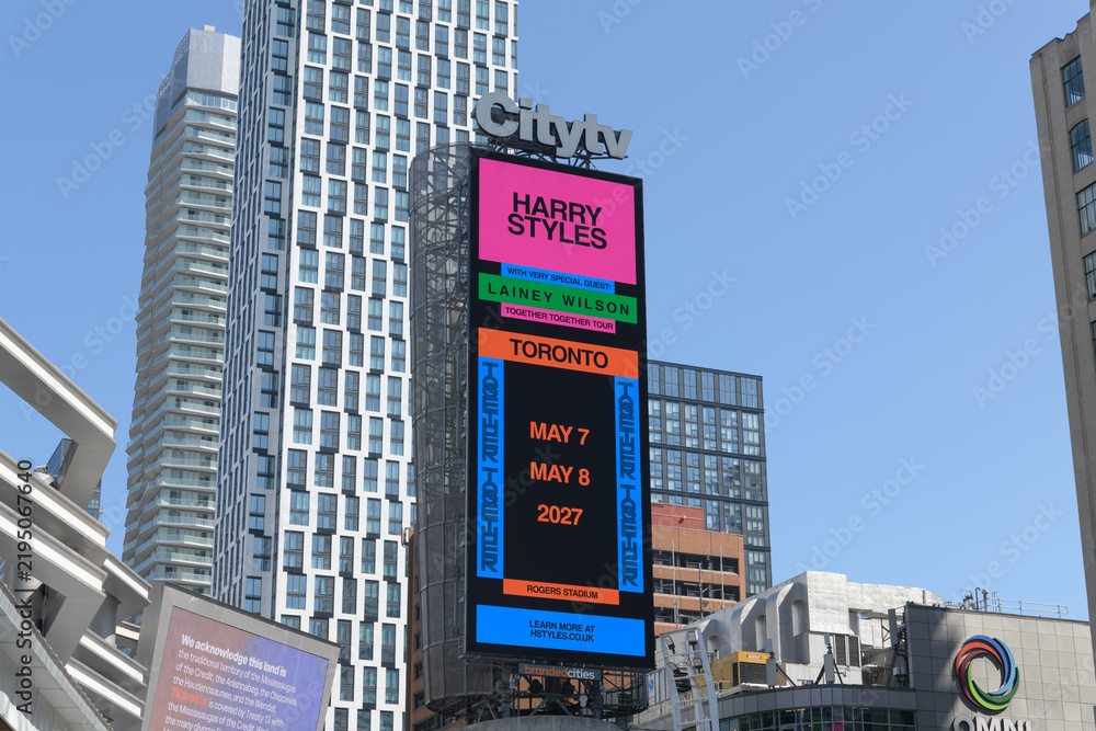 Obraz premium large-format digital spectacular (on Citytv tower) featuring concert promotion for Harry Styles and Lainey Wilson slated for May, 2027 at Rogers Stadium, Sankofa Square, Toronto