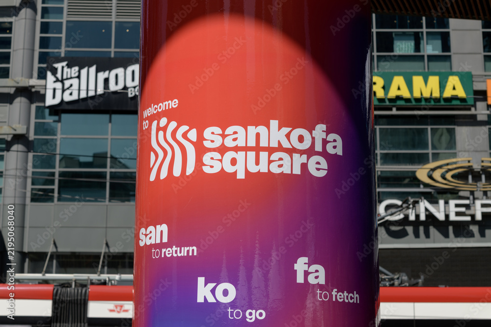 Obraz premium concrete pillar with signage at Sankofa Square (looking north to The Tenor and defocused signage on the outside), Toronto