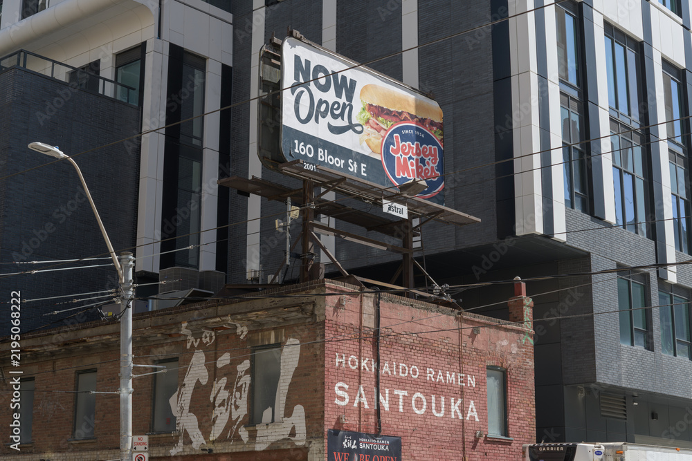 Obraz premium rooftop billboard advertising Jersey Mike's - 160 Bloor St E location - on Hokkaido Ramen Santouka, ramen restaurant at 91 Dundas St E, Toronto