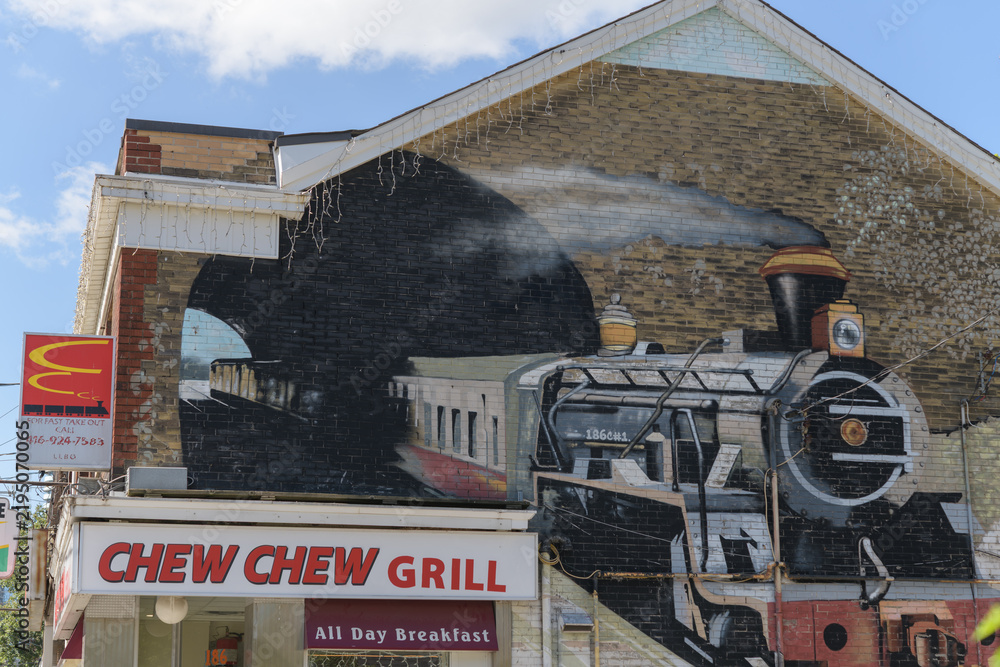 Obraz premium Chew Chew Grill sign and mural of a steam engine at 186 Carlton (east facing wall), Toronto