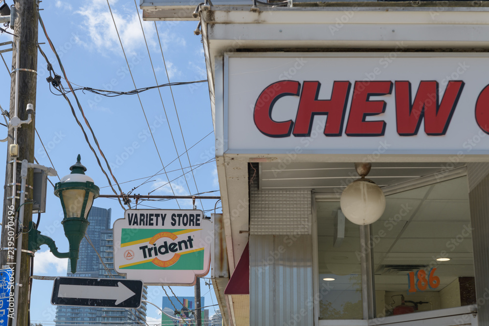Obraz premium Chew Chew Grill sign and ghost Trident gum blade sign outside a variety store known as J&S Convenience, 184 Carlton St, Toronto