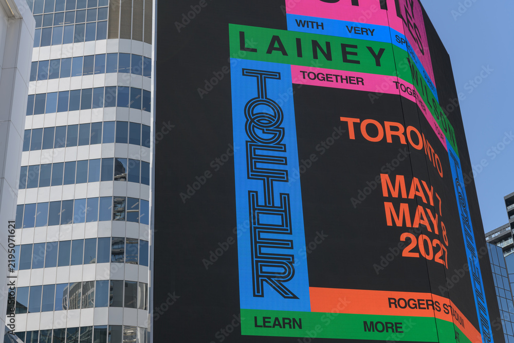 Obraz premium concert promotion for Harry Styles: Together, Together, featuring Lainey Wilson displayed on a digital spectacular at Sankofa Square, Toronto