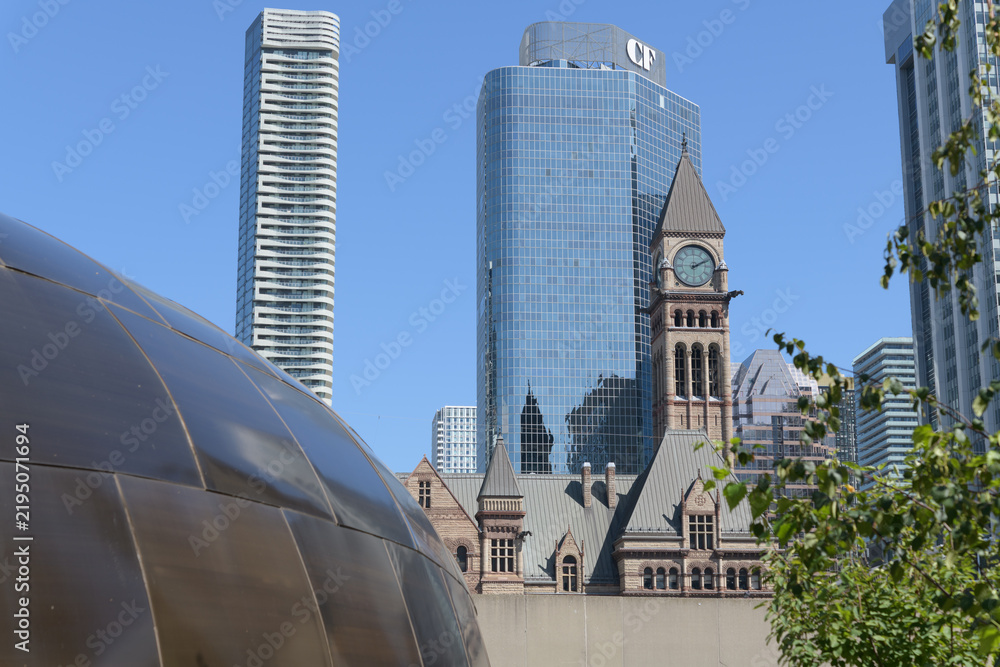 Obraz premium contrast of the Teaching Lodge at the Spirit Garden contrast with Massey Tower condos, Cadillac Fairview business tower, and clock tower of Old City Hall, Toronto