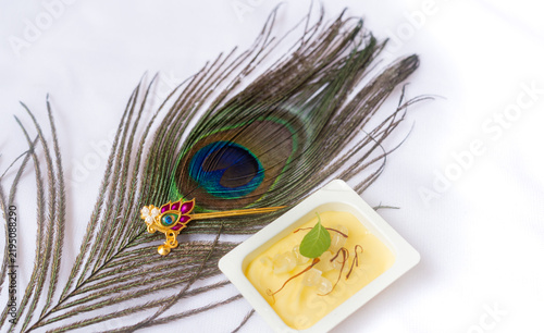 Makhan misri or butter candy Pot with Flute and Peacock Feathers for Krishna Janmashtami or Krishna Brithday Festival concept.