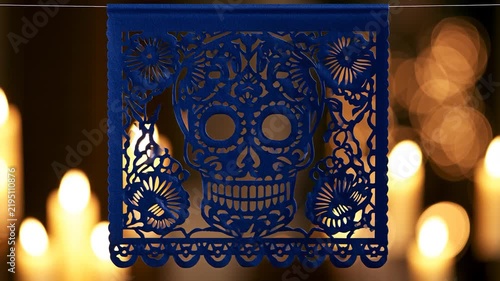 Deep Blue Papel Picado Skull Decoration with Warm Candle Bokeh