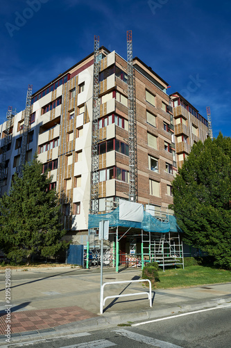 residential building facade renovation with scaffolding and thermal insulation panels