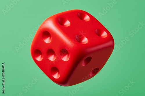 Red Dice Floating on Green Background