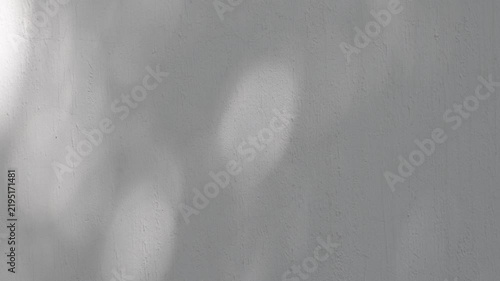 Abstract Moving Light and Shadows on Concrete Wall, Minimalist Atmospheric Background.