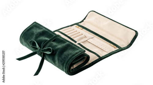 Compact forest-green velvet jewelry travel roll with cream-lined compartments and a refined soft structure, designed as an elegant travel storage accessory. Isolated on White background.