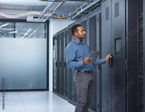 Engineer inspecting a backup power enclosure for servers in Africa