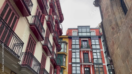 Colorful historic buildings with traditional balconies and wooden shutters in Casco Viejo, the old town of Bilbao, Spain