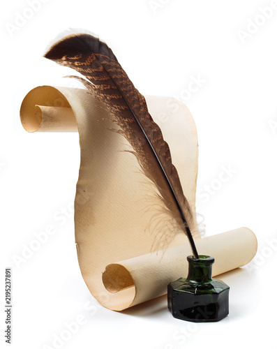 A quill rests in a green ink pot next to a scroll of parchment. Quill and ink on parchment create a classic writing setup in a simple arrangement on a white background