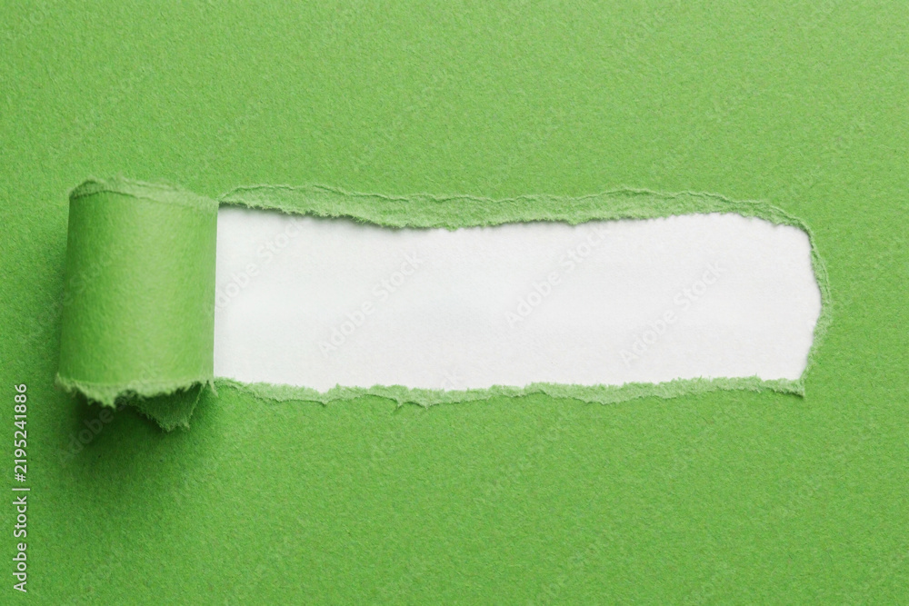 Obraz premium Green paper torn open revealing white background. Use this for copyspace, reveals, or uncovering hidden info. Perfect for creative backgrounds or adding text.