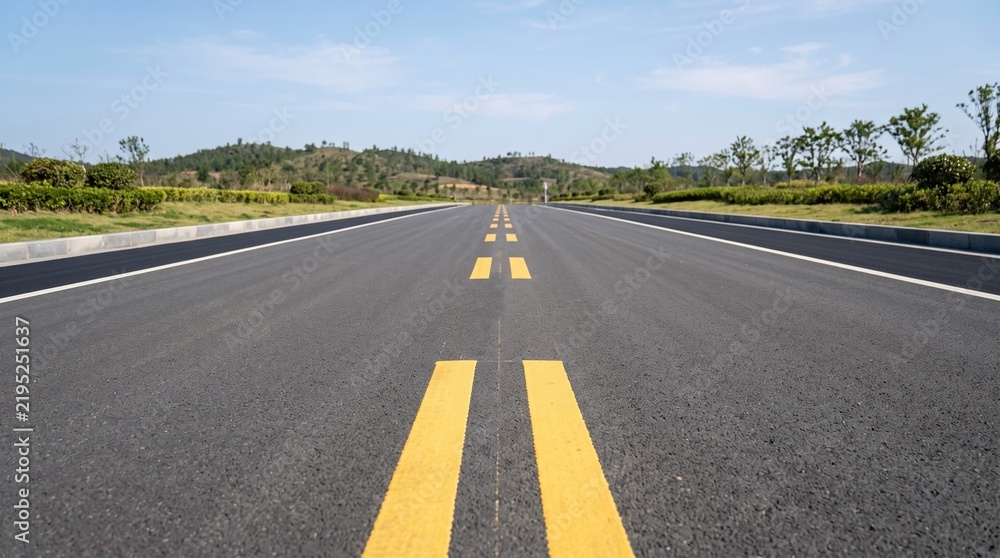 Obraz premium Empty asphalt road with double dashed yellow lines in the center