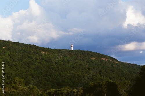 Photography tower on mountain trees clouds blue sky