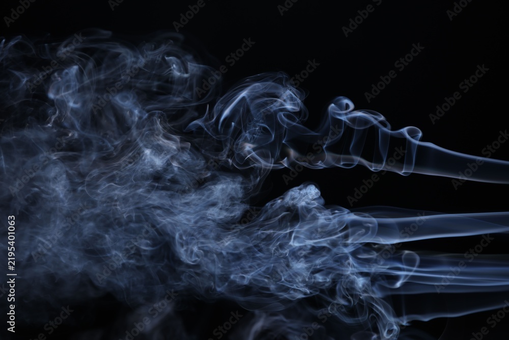 Obraz premium Beautiful smoke in light on black background