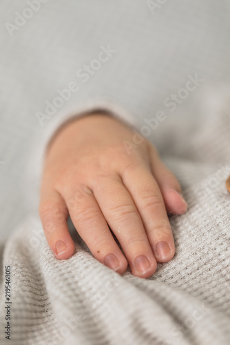 Closeup of a newborn infant baby hand while sleeping