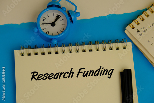Foto Research funding on white paper background