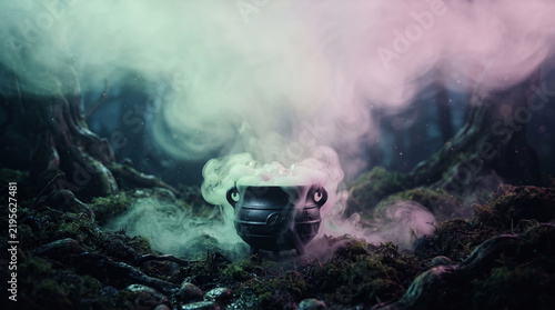 Bubbling witch cauldron with colorful smoke on mossy forest ground at night