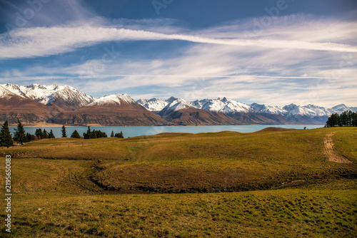 Driving up Braemar  road alongside between Lake Tekapo and Pukaki towards the snowy Mount Cook mountain ranges