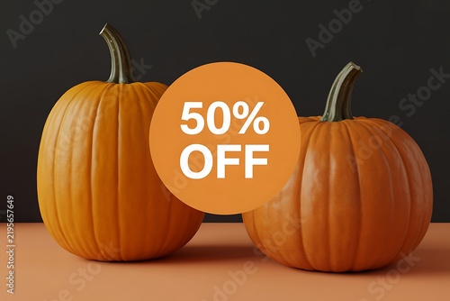 Two orange pumpkins placed on a surface with a promotional fifty percent off text circle graphic