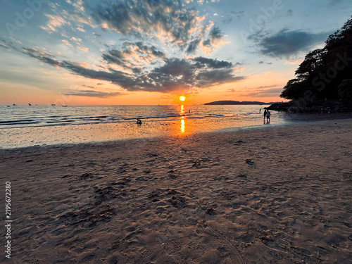 Dramatic Sunset at Ao Nang Beach with Silhouetted People, Krabi, Thailand
